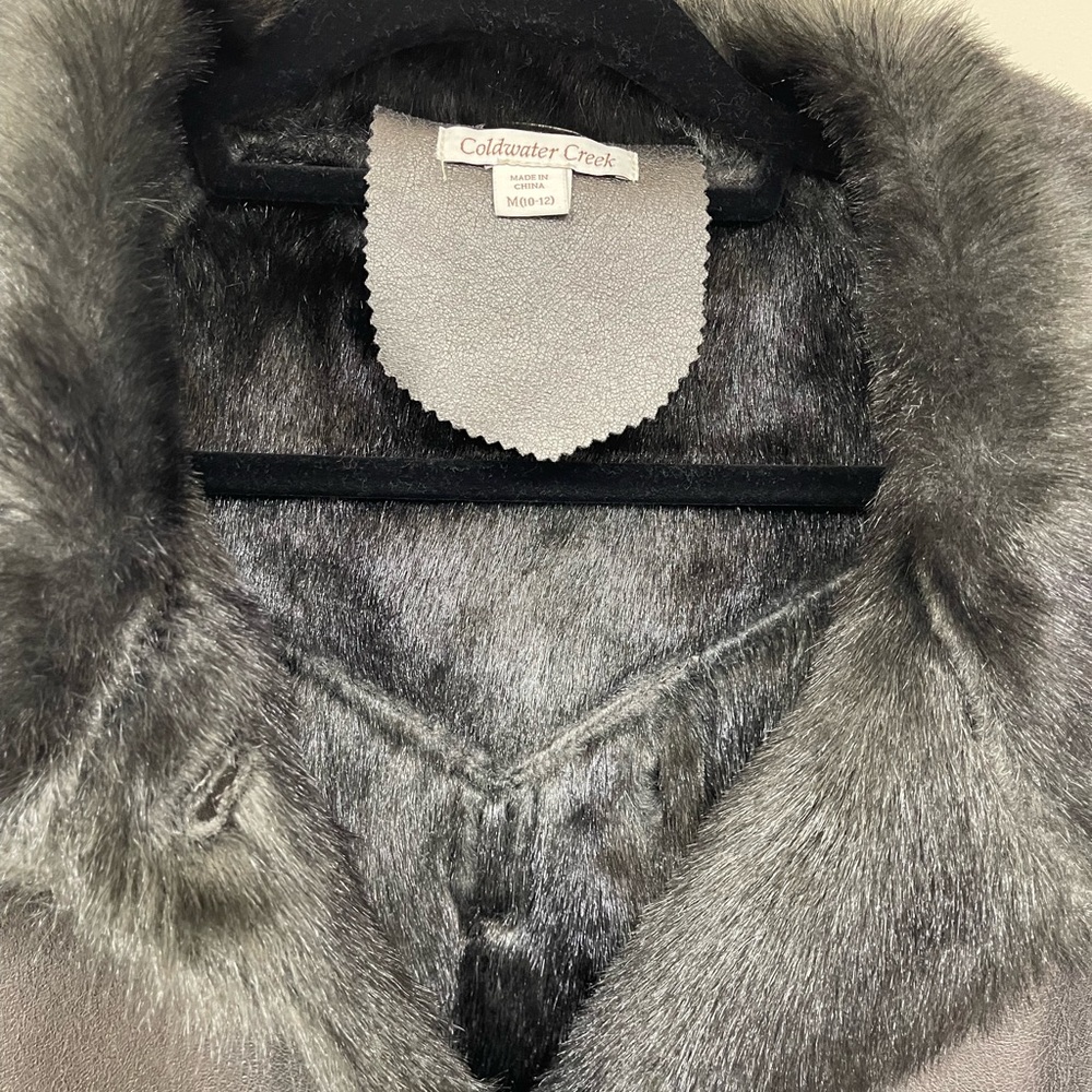 Woman’s faux fur leather swing coat by Coldwater Creek.